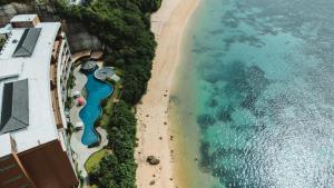 an aerial view of a beach and the ocean at Ulu Segara Luxury Suites & Villas in Nusa Dua