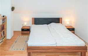 a bedroom with a large bed with two night stands at Cozy Apartment In Harrislee With Wifi in Harrislee