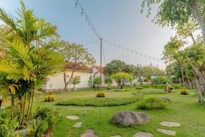 a park with trees and rocks in a yard at Hoa Lu Garden Resort in Ninh Binh