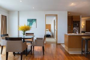 a kitchen and dining room with a table and chairs at Tower Club at lebua in Bangkok