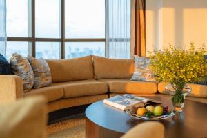 a living room with a couch and a table at Tower Club at lebua in Bangkok