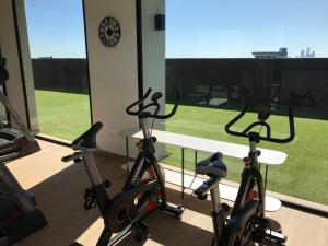 a gym with exercise bikes in a room with a window at Ed Hassler #307 Mariale’s in Asunción