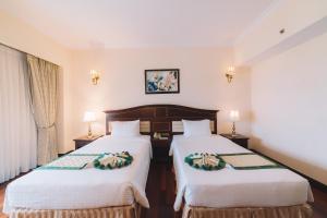 Letto o letti in una camera di Saigon Dalat Hotel