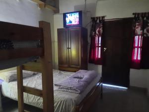 a bedroom with a bunk bed and a tv at Domingo in Goya