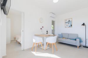 a room with a table and two chairs and a couch at NEW!!! Luminose beach house in Pakoštane