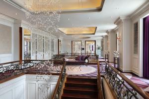 a large lobby with a staircase and a room at Tower Club at lebua in Bangkok