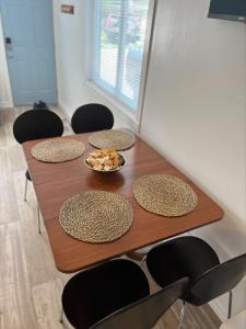 a table with four chairs and a bowl of food on it at Casa Di Nonna in Wasaga Beach