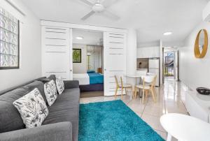 a living room with a couch and a dining room at Mooloolaba Beach Club Paradise 2 Bedroom Apartment in Mooloolaba