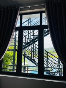 a window with a view of a bridge at Jade Hotel in Phong Nha