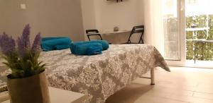 a bedroom with a bed with blue pillows on it at Luxury apartment 3 rooms near metro in Athens