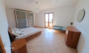聖多納托的住宿－La casa di là.，一间卧室设有一张床和一个大窗户