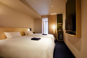Postel nebo postele na pokoji v ubytování HOTEL AMANEK Kanazawa