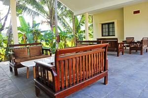 a group of benches sitting on a patio at Perta Prana Amarta in Mendut