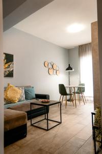 a living room with a couch and a table at Centro Alexandroupolis in Alexandroupoli