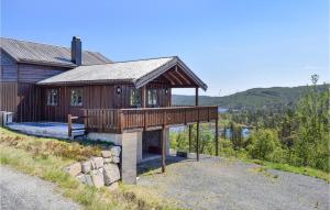 a house on a hill with a deck and a porch at 4 Bedroom Lovely Home In Dalen in Dalen