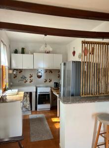 a kitchen with white cabinets and stainless steel appliances at Casa Elisa in Gargnano