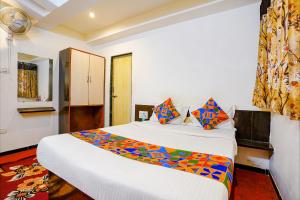 a hotel room with two beds and a window at FabExpress Sai Chatra in Nashik