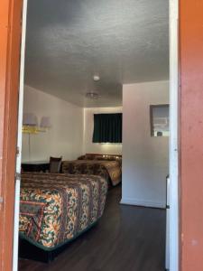 a hotel room with two beds and a room with a bed sqor at Johnston's Motel in Garberville