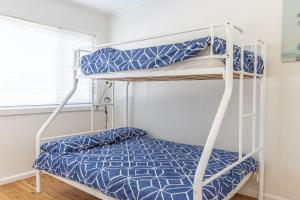 a bedroom with two bunk beds in a room at Bright and Breezy in Sussex inlet