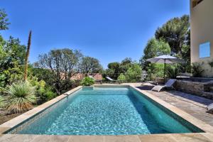 a swimming pool in the backyard of a house at Lantana luxury property in Bormes-les-Mimosas +16 photos