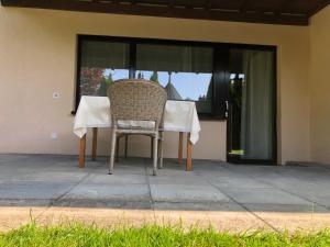 a table and chair sitting on a patio at Apartment Deluxe with Garden Rapperswil-Jona in Jona