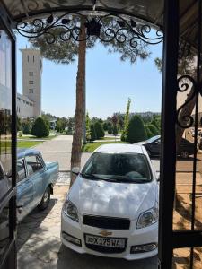 biały samochód zaparkowany na parkingu w obiekcie KHAN APARTMENTS w Samarkandzie