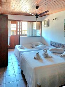 Ένα ή περισσότερα κρεβάτια σε δωμάτιο στο Pousada Village Paraty Centro