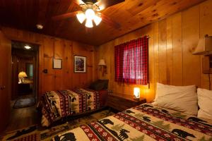 a bedroom with two beds and a ceiling fan at Along The River in Yosemite West