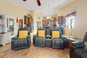 a living room with two chairs and a kitchen at South Valley Retreat in Avondale