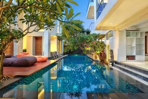 a swimming pool in the middle of a villa at ECHO BEACH DESIGNER APARTMENT in Canggu