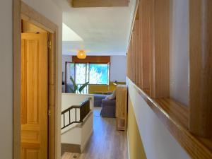 a hallway leading to a living room with a staircase at Casa Aloha, parking incluido in San Vicente de la Barquera