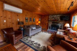 a living room with a couch and a fireplace at Along The River in Yosemite West