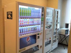 two vending machines in a room with drinks at Hotel Route-Inn Tsu Ekiminami -Kokudo23gou- in Tsu