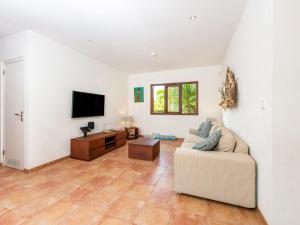 a living room with a couch and a tv at Holiday villa at Jan Thielstrand in Willemstad in Jan Thiel