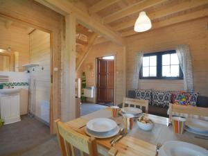 a kitchen and dining room with a table and chairs at Nice holiday home located 800 m from the sea in Mielenko