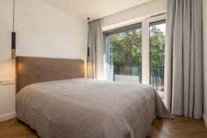 Postel nebo postele na pokoji v ubytování Apartamentai Kopa