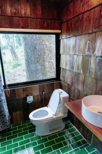 a bathroom with a toilet and a sink at Baan Nhuer Mek บ้านเหนือเมฆ Coffee and Desk on the Cloud 