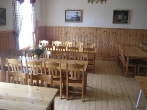 a dining room with wooden tables and chairs at Perfect house for groups many facilities 14 Miles from skiarea Bran s in Sysslebäck