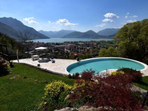 a swimming pool in a yard with a view of a lake at Villa in Pisogne with pool garden and lake view in Pisogne