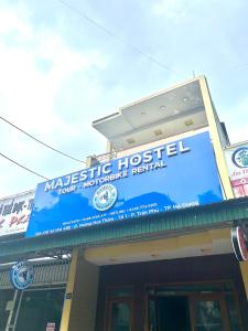 a building with a sign for a wrestling hospital at Majestic Hostel - Tour & Motorbike Rental in Ha Giang