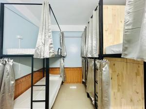 a room with three bunk beds and a window at Majestic Hostel - Tour & Motorbike Rental in Ha Giang