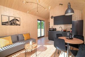a living room and kitchen with a couch and a table at Stodoły Słona Zatoka in Władysławowo