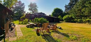 a group of chairs sitting in a yard at Pirts Rozēni in Saulkrasti