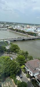 a view of a river with a pier and a city at Mộc Homestay VIP in Ấp Ðông An (1)