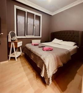 a bedroom with a bed and a desk and a television at Venüs apart in Istanbul