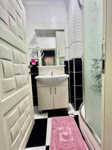 uma casa de banho com um lavatório, um WC e um espelho. em Venüs apart em Istambul