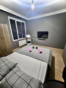 a bedroom with two beds and a flat screen tv at Venüs apart in Istanbul