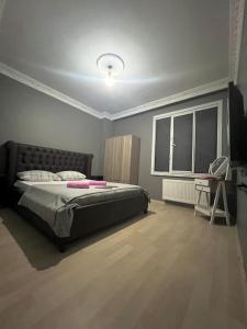 a bedroom with a bed and a table and a chair at Venüs apart in Istanbul