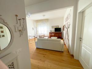 a living room with a white couch and a table at Big Apartment with Free Parking in Florence