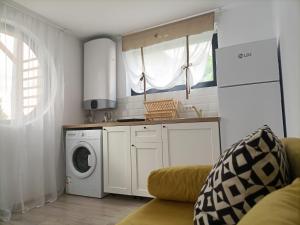 a kitchen with a washing machine and a washer at Tiny Village Mamaia Nord - House 1 in Mamaia Nord